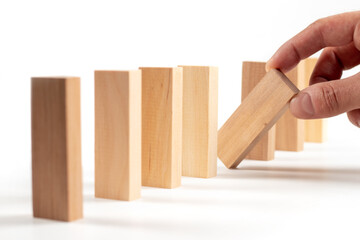 Close up of man hand planning, risk and strategy in business. Businessman gambling placing wooden block on a tower