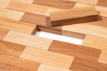 stacked wooden blocks on white. wood game jenga close up. wooden background close up.