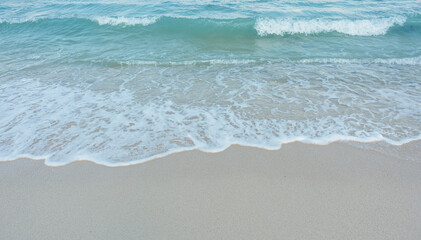 Soft wave of blue ocean on sandy beach. Summer vacation in island. clear azure water Background.