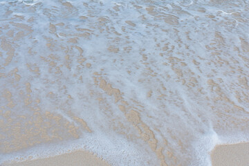 Soft wave of ocean on sandy beach. Summer vacation in island. clear azure water Background.