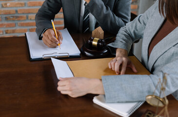 business people and lawyers discussing contract papers sitting at the table. Concepts of law,...