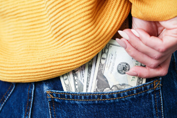 Pocket money background. Dollar bills in rear pocket. Woman in blue jeans. Sexy girl in trousers....