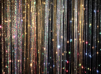 Shiny tinsel curtain with light sparkles. Celebration backdrop, party decorations - obrazy, fototapety, plakaty