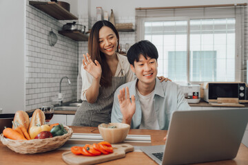 Couple cooking together in their kitchen at home