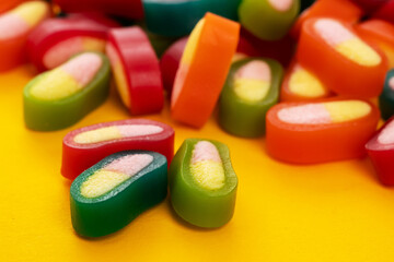 Jelly gummy candy. Colorful sweet confectionery isolated on yellow background