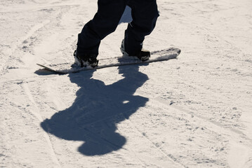 Snowboarder on the ski slope with shadow o. Snowboarder on a ski slope in the mountains. Civetta...