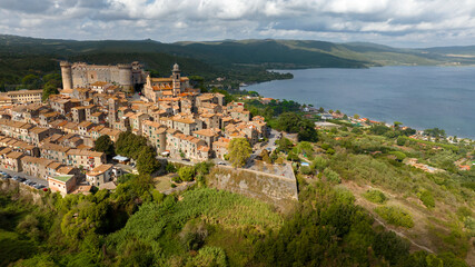 Fototapeta na wymiar Aerial view of Bracciano, in the metropolitan city of Rome, Italy. The town is located on the shores of Lake Bracciano. In the historic center there is the castle and cathedral of Santo Stefano.