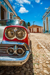 Old classic car detail in a road of Trinidad in Cuba