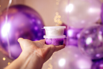 Ready-made slime of pearlescent and purple colors in boxes.