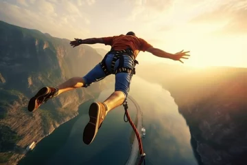 Küchenrückwand glas motiv Man bungee jumping from the cliff. Extreme sports © pilipphoto