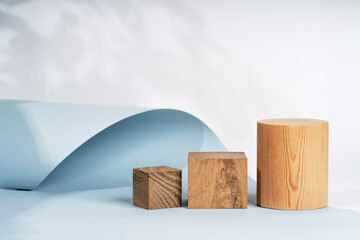 Podium for exhibitions and product presentations, material: stone, wood. Beautiful blue background....