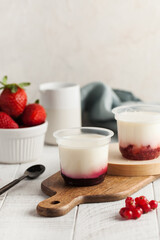 Yogurt with berry filling in a cup. Dairy products.
