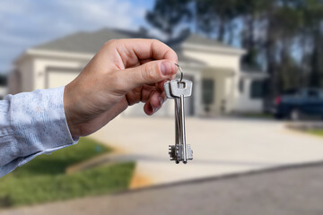 Man hand holding on finger keys to new house.