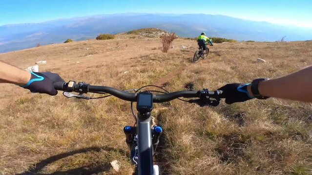 Group of friends Speed riding mountain bike downhill ride on a rocky path