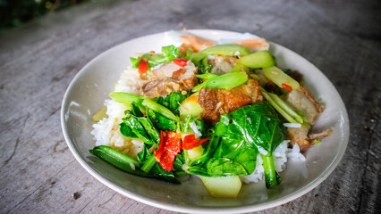 Thai food, kana moo krob.(fried kale mixed crispy pork),Crispy Pork fried with Kale Thai delicious food, closeup, side view