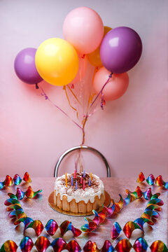 Birthday cake with colorful balloons