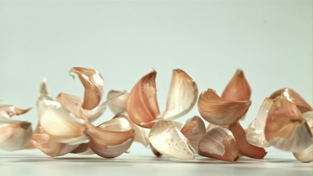 Fresh garlic falls on the table. Filmed on a high-speed camera at 1000 fps. High quality FullHD footage
