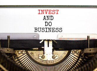 Invest and do business symbol. Concept word Invest and do business typed on beautiful old retro typewriter. Beautiful white paper background. Invest and do business concept. Copy space.