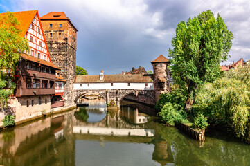 Fototapeta na wymiar Colourful historic old town with half-timbered houses of Nuremberg. Bridges over Pegnitz river. Nurnberg, eastern Bavaria, Germany. High quality photo