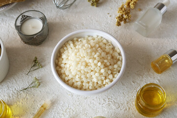 Bees wax pellets with herbs and essential oils - ingredients for homemade cosmetics
