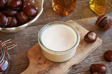 Homemade horse chestnut ointment in a jar on a wooden table