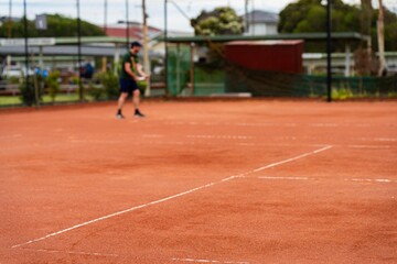 Fototapeta premium tennis player playing on a clay tennis court in australia