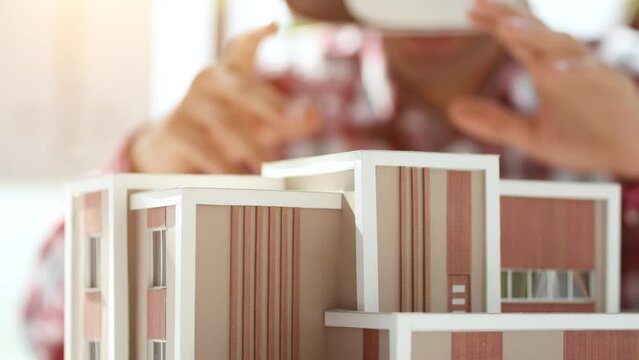 Virtual reality futuristic design technology. Architect or design engineer in VR headset for BIM technology designing a 3D model