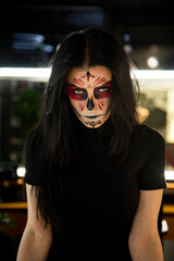 portrait of a person with scary  halloween mask  vampire with skull in dark studio. Santa de muerte conseption. 