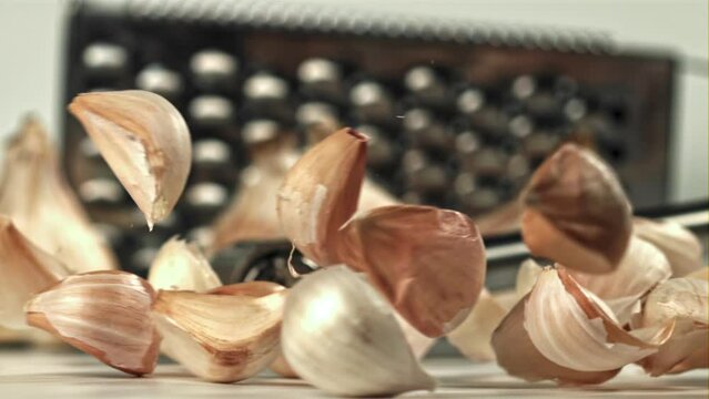 Fresh garlic falls on the table. Filmed on a high-speed camera at 1000 fps. High quality FullHD footage