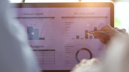 Business partnership coworkers using a tablet to chart company financial statements report and profits work progress and planning in office room.
