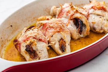 chicken rolls stuffed with dry tomatoes in bacon