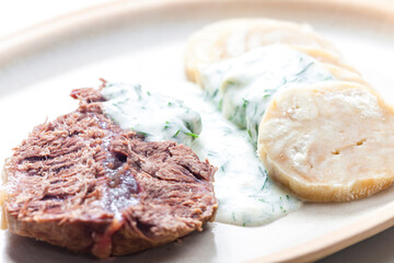 beef meat with dill sauce and dumplings