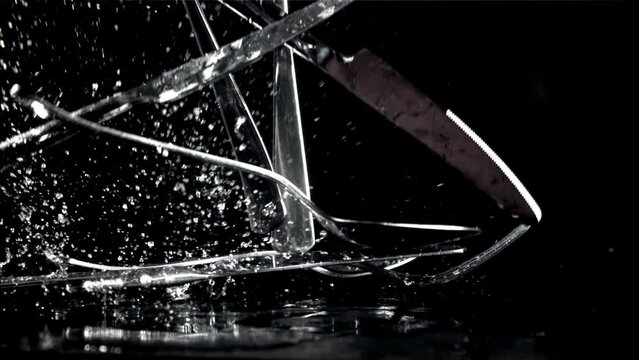 Cutlery falls on a black wet table. Filmed on a high-speed camera at 1000 fps. High quality FullHD footage