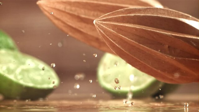 The lime squeezer falls on the wet table. Filmed on a high-speed camera at 1000 fps. High quality FullHD footage