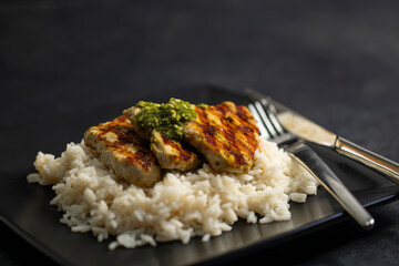 grilled poultry meat with pesto served with rice