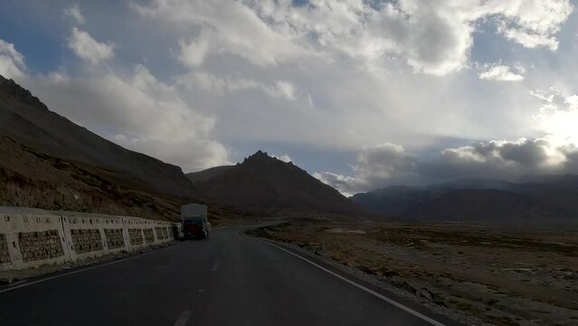 Driving Across Rocky Terrain in Ladakh with Passing Trucks ,Mountains and Clouds