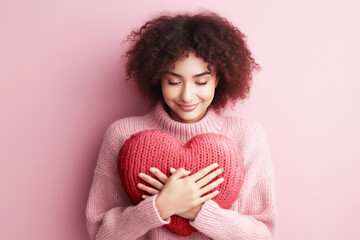 Young woman hugging a heart shaped for self love concept