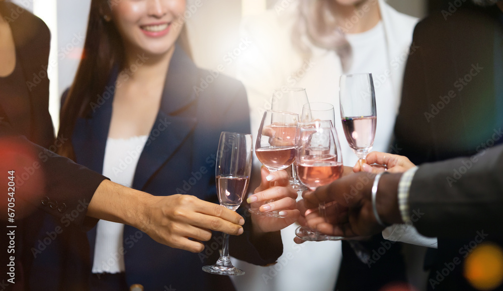 Wall mural closeup hand holding glassware. business people celebrate making a toast on event party at office. c