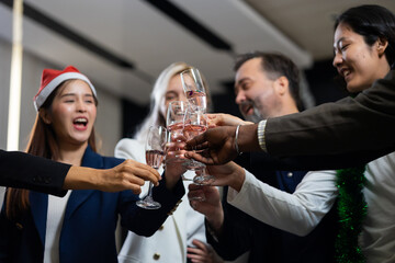 Closeup hand holding glassware. Business people celebrate making a toast on event party at office. Celebration Success Concept