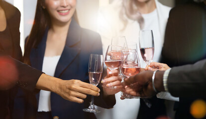 Closeup hand holding glassware. Business people celebrate making a toast on event party at office....