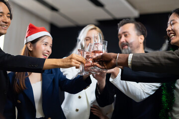 Closeup hand holding glassware. Business people celebrate making a toast on event party at office. Celebration Success Concept