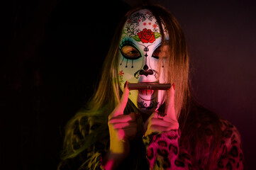 A fashion-forward woman with masquerade mask  poses in a leopard print coat, immersed in neon...