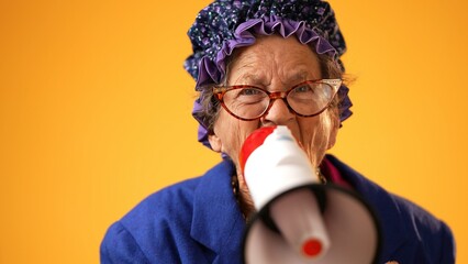 Closeup portrait of funny toothless old elderly senior crazy grandmother woman yelling into...