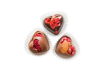 top view of chocolate pralines in heart form isolated on white background