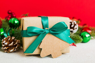 New Year Christmas mood, gift box, branches of a christmas tree, New Year decorations on a colored background