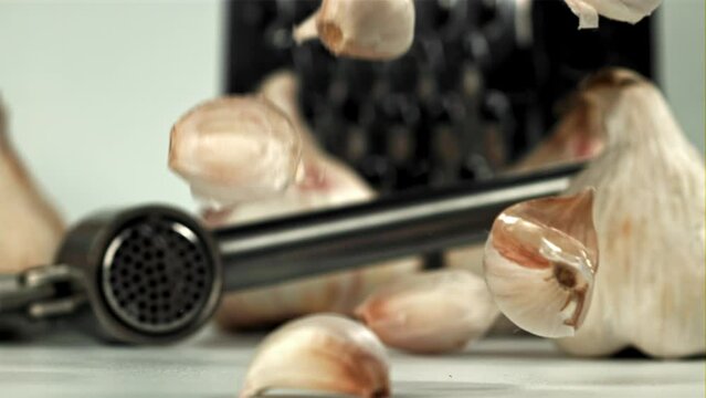 Fresh garlic falls on the table. Filmed on a high-speed camera at 1000 fps. High quality FullHD footage