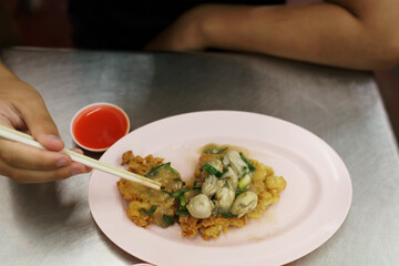 Omelette with oyster in Thai cafe in Chinatown, Bangkok 