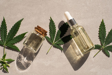 CBD oil hemp products. glass bottle with CBD oil, hemp leaves. Medicinal cannabis with extract oil. Cosmetics CBD oil