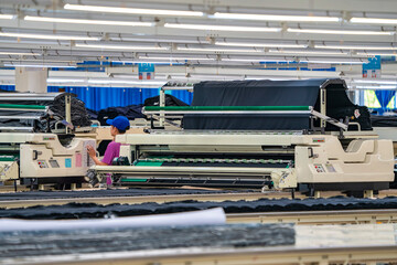 Industrial cloth cutting machine and fabric cutting area in garment factory in industrial zone in...