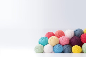 colorful yarn balls pile on white background with copy space - obrazy, fototapety, plakaty